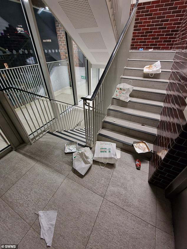 One resident said: 'When it's cold or raining, they gain access to our estate and eat inside the blocks.' Pictured: Takeaway bags and boxes scattered in one of the housing blocks