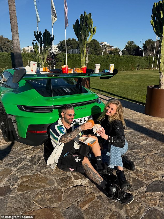 As Iranian authorities continue to tighten their control over society, with security officials saying they will stay as long as 'enemy threats' remain, the privileged offspring continue to live extravagantly abroad and at home. Pictured: Sobhai and Neimas posing next to a sports car as they enjoy some fast food together