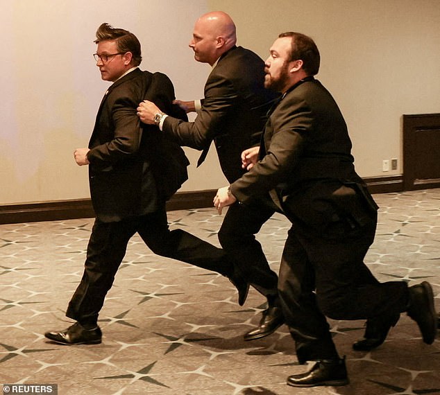 House Speaker Mike Johnson being rushed out of the venue by Secret Service members