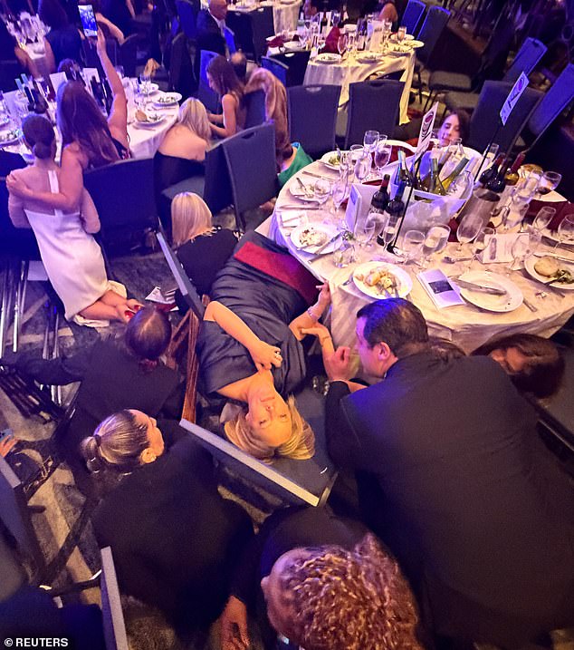 Several gunshots rang out as panicked attendees immediately ducked under their tables to protect themselves. A few journalists stayed seated or knelt, filming the chaos
