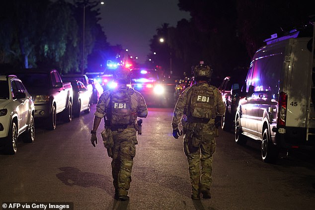 An FBI tactical team prepares to enter a house associated with the suspected White House Correspondents' Dinner shooter in Torrance, California