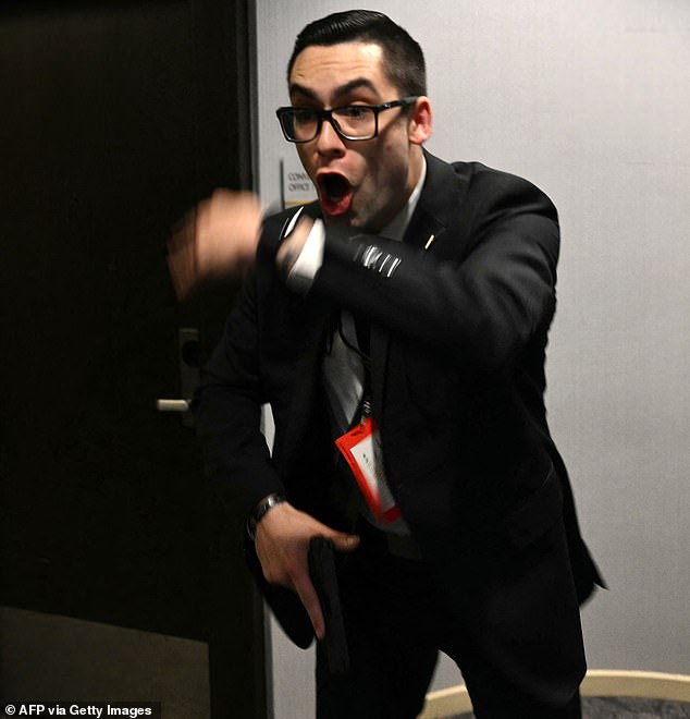 Allen wrote in his manifesto that Secret Service agents would only be targets if necessary and that he would try to incapacitate them 'non-lethally if possible.' A Secret Service agent is pictured shouting during the shooting
