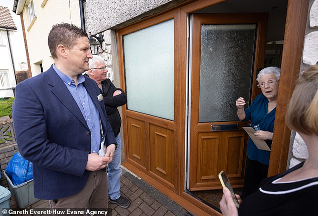 Jason O'Connell, Reform's candidate for Merthyr Tydfil, canvassing at a doorstep on the Gurnos Estate