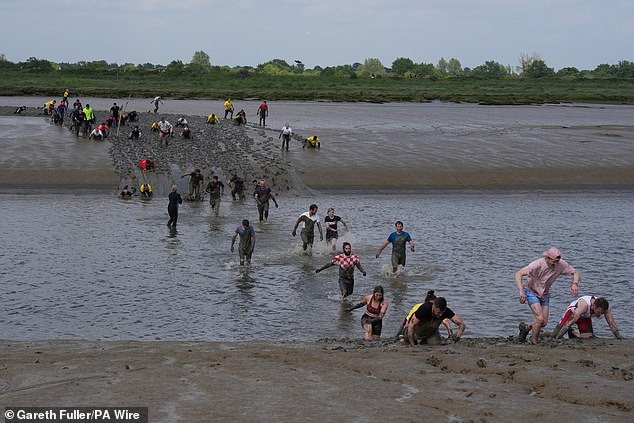 The hundreds of of plucky racers waded through the river, which was predicted to be around 8C in temperature on the race day on Sunday