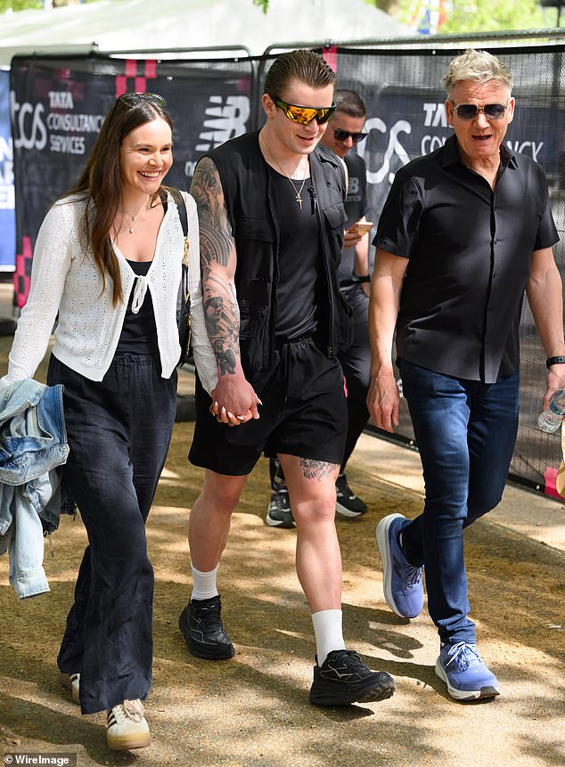 Adam was spotted supporting his new family-in-laws as he waited on the sidelines for Tilly to victoriously cross the finishing line in the capital city