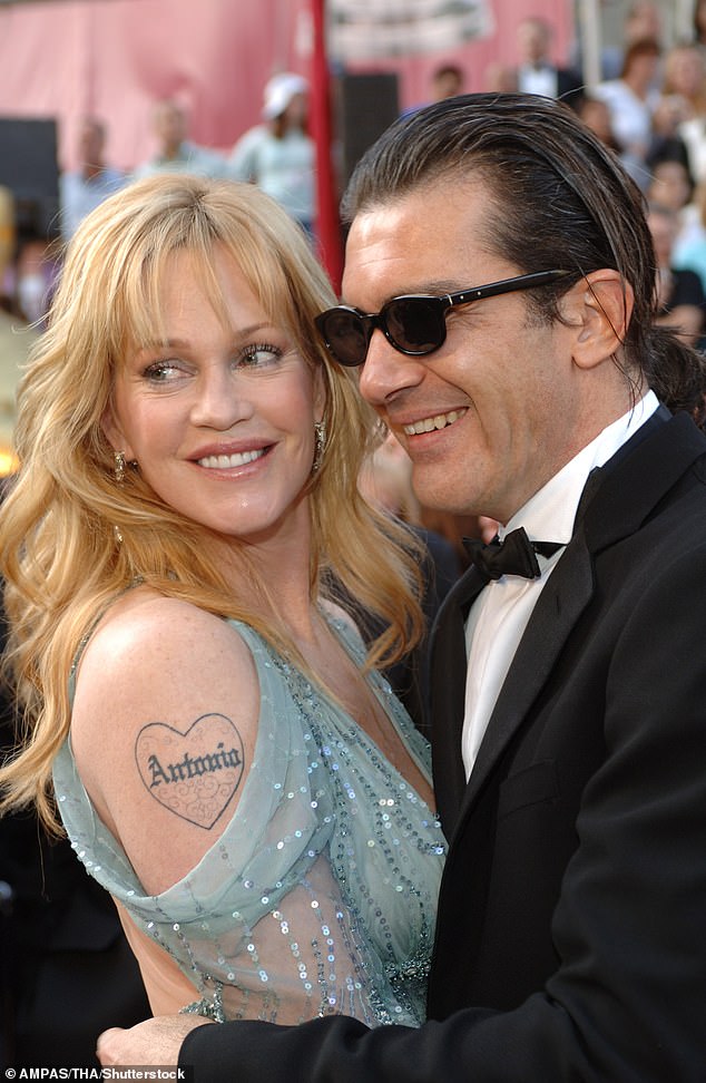 Griffith pictured with her then-husband in 2005, showing off her 'Antonio' tattoo
