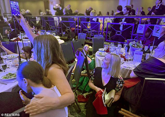 Footage shows guests in tuxedos and evening gowns huddled under tables as Secret Service patrol the ballroom floor