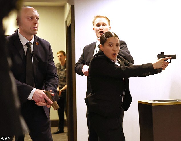 Secret Service agents were seen with their guns drawn as they gave people orders