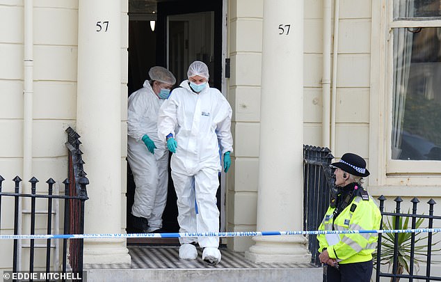 Forensic scene of crime officers are seen leaving Moon's House on Sunday. The accommodation is described as a 'hostel' and a 'halfway house' by locals