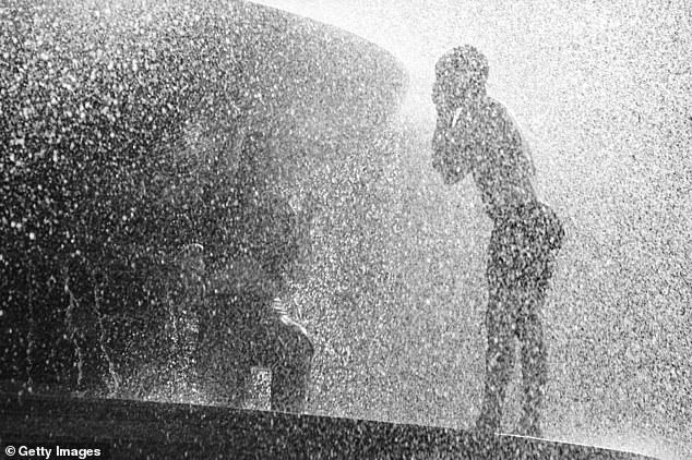 The average maximum temperature at Heathrow in August 1997 month was a balmy 25.8C, with a top temperature of 31.5C reached. Pictured: One of the fountains of Trafalgar Square provides relief from the heatwave