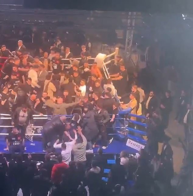 Dozens of people were seen throwing punches and kicking each other as the fight spilt out of the boxing ring and into the arena itself