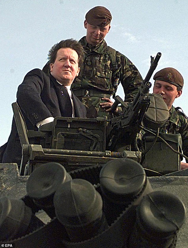 Taking aim: Then-Labour defence secretary George Robertson on a Challenger tank in 1999