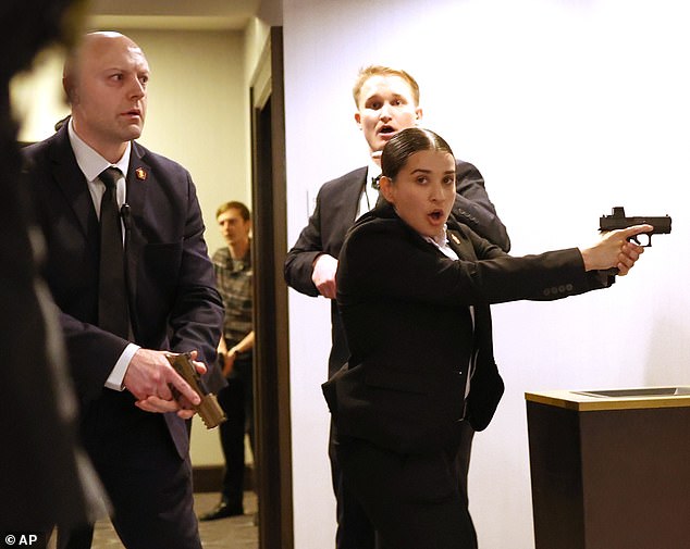 Several Secret Service agents were seen with their guns drawn moments after shots rang out in the ballroom