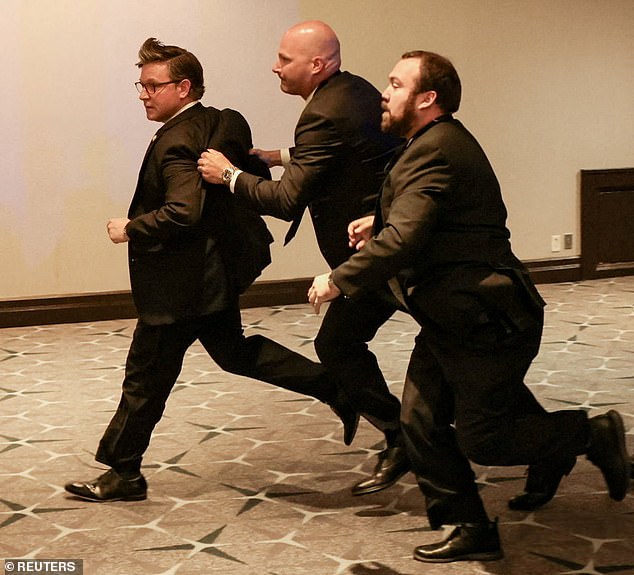 House Speaker Mike Johnson being rushed out of the venue by Secret Service members
