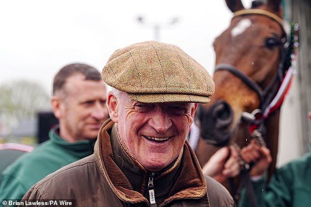 Heneghan has released clips of him marching towards a private jet at Aintree with a suitcase in his hand, and shaking hands with trainer Willie Mullins (above)