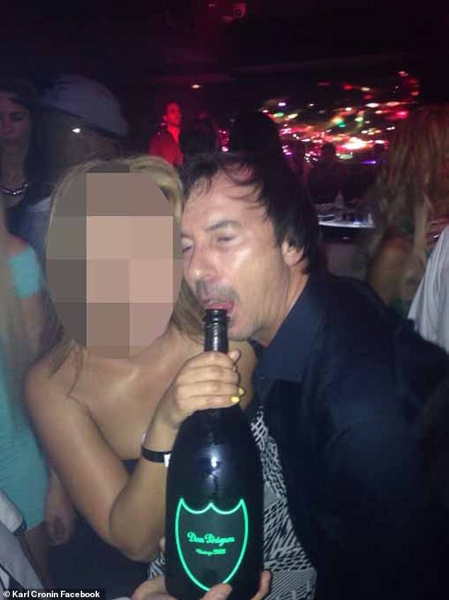 Cronin appears to take a drink from a bottle of Dom Perignon vintage champagne at a nightclub in Dubai