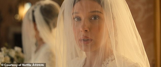 The star looks incredible with natural make-up and a veil covering her face as she looks into the camera