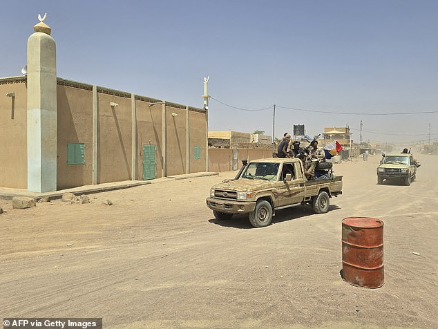 Tuareg rebels of the Azawad Liberation Front (FLA) coalition ride on the back of a pickup truck in Kidal, on April 26, 2026