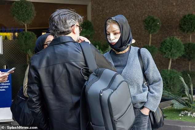 She was surrounded by aides who assisted her in her departure