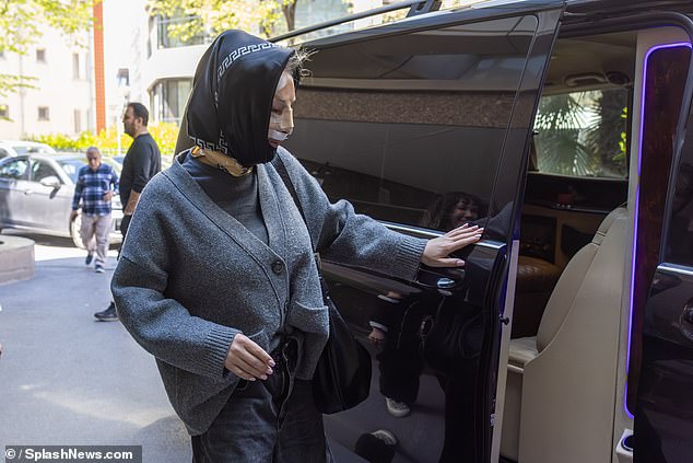 Nadia appeared to be steadily making her way into the car following the surgery