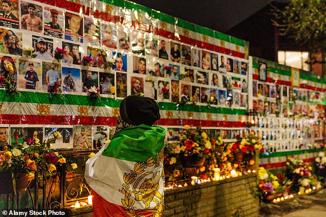 The wall (pictured in February) is a shrine to the thousands of protesters were killed by the regime in Iran earlier this year