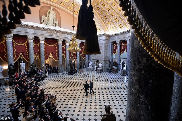 Speaker of the House Mike Johnson, R-La., left and Britain's King Charles III walk through Statuary Hall