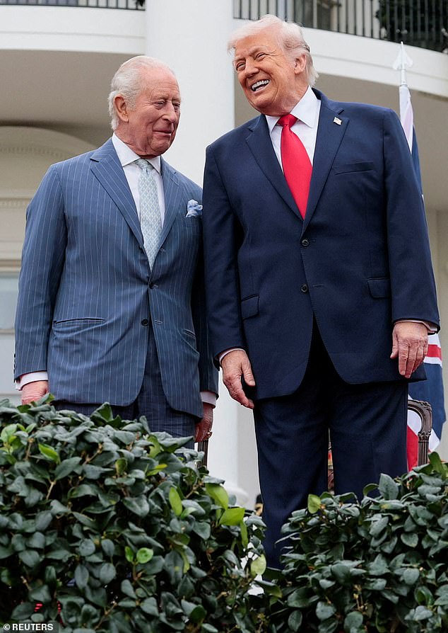 King Charles stands smiling with President Donald Trump during the arrival ceremony on the South Lawn of the White House in Washington