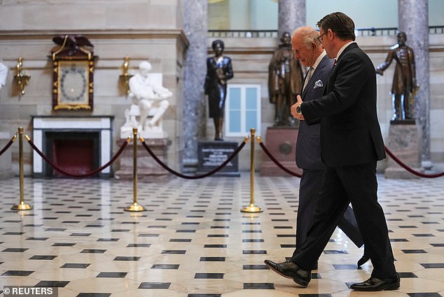 King Charles and Mike Johnson walk through Statuary Hall before a joint meeting of Congress in the House Chamber of the US Capitol