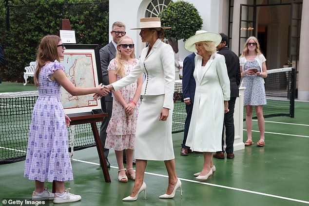 First lady Melania Trump and Queen Camilla greet school children as they attend a cross-cultural educational event
