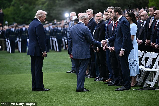 King Charles III shakes hands with Vice President JD Vance as he greets members of the Trump administration on the South Lawn