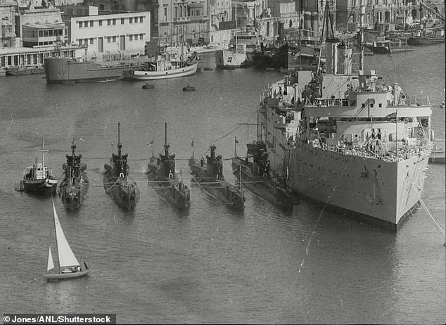 HMS Trump sits alongside other submarines next to HMS Forth in Malta in the 1950s