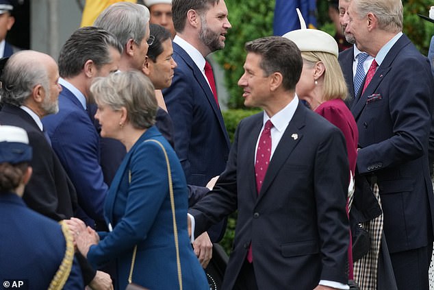 Sir Christian pictured greeting US Defence Secretary Pete Hegseth during the King's state visit on Tuesday