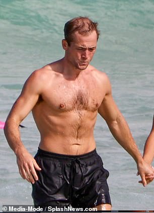 Taron was pictured walking out of the water in Bondi, Sydney, holding hands with Brooks, 29 - just like Daniel in his memorable Casino Royale beach scene