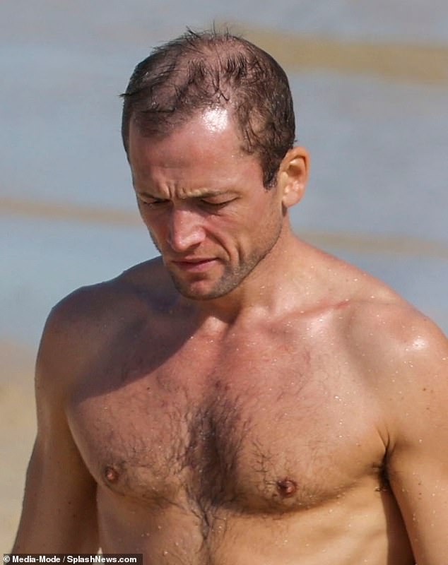 Taron had a sun-kissed tan during his beach appearance