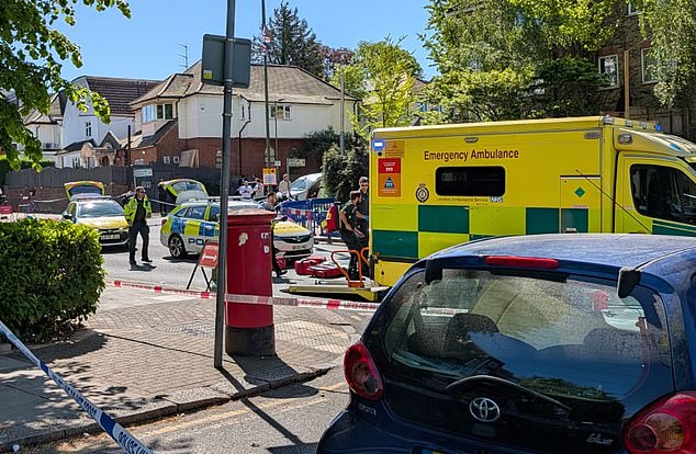 A photo of the scene earlier today, with an ambulance parked on the road alongside several police cars