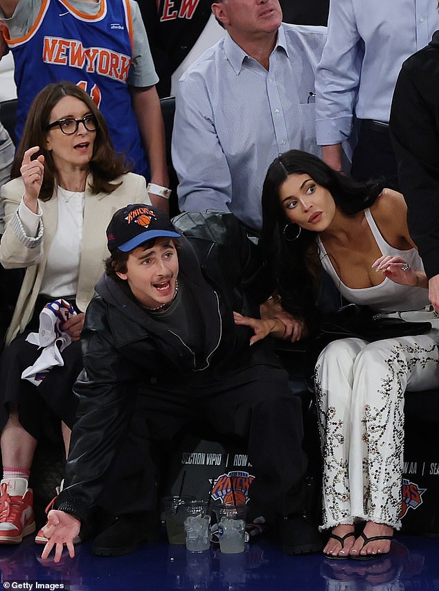The four-time Oscar nominee, sitting between his cosmetics mogul girlfriend and the Saturday Night Live legend, was animated watching his team against the Atlanta Hawks