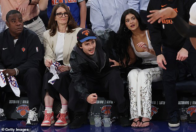 The Kardashians star sizzled for the date night in a very low-cut white tank top and bedazzled white jeans