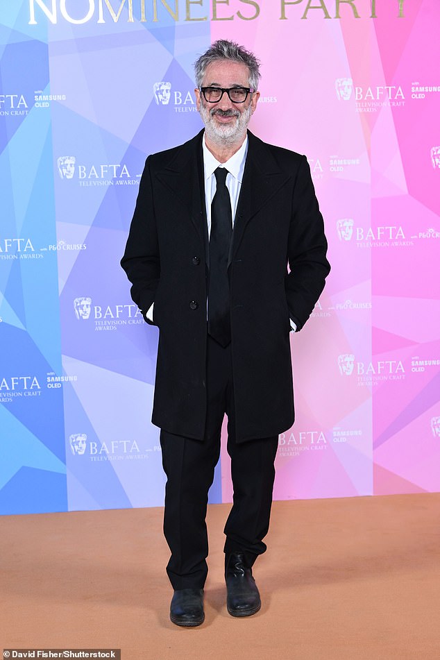 David Baddiel kept his look traditional in a black suit for the lavish bash