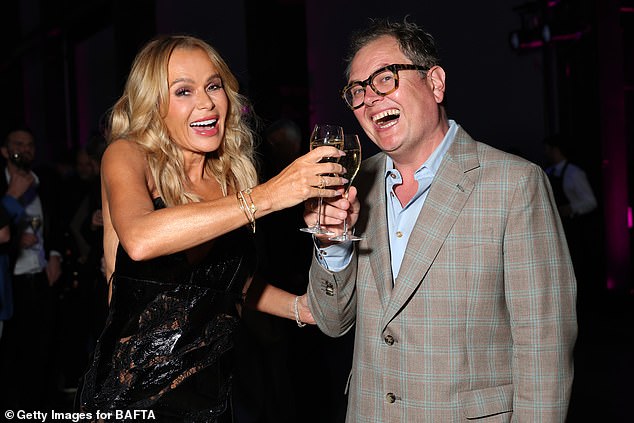 Pals Amanda and Alan raise a raise of fizz inside the bash