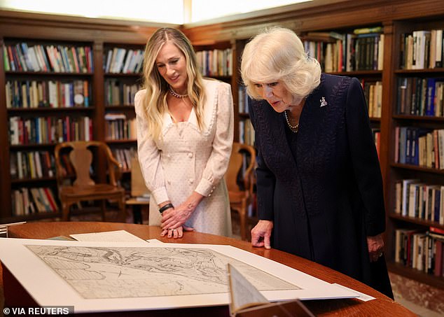 Sarah Jessica Parker and  Queen Camilla examine artifacts on display during a literary engagement at New York Public Library