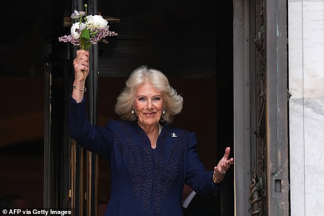 Camilla holds up a bouquet of flowers as she attends a literacy event at the New York Public Library in New York, on April 29, 2026