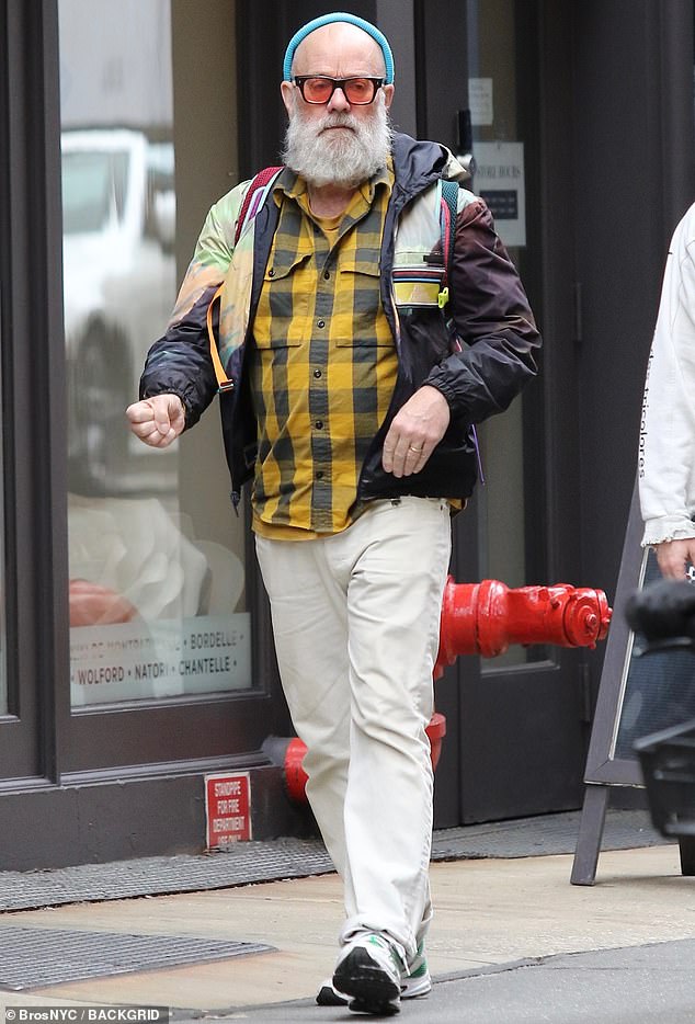 For his latest sighting, he wore a colorful outfit including his tie-dye jacket, a yellow and white checked shirt, a sky blue beanie and orange-tinted shades