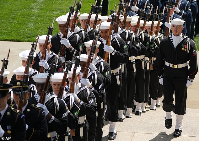 Honor guards from all branches of the military service of the US march in before Charles and Camilla arrive to lay a wreath at the Tomb of the Unknown Solider at Arlington National Cemetery -- April 30, 2026
