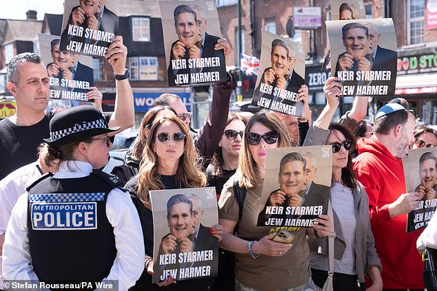 Protesters held placards criticising the Prime Minister on Thursday morning following the stabbing on Wednesday