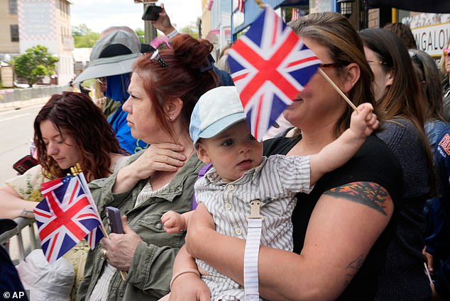 Child's play: Elsewhere in Virginia yesterday even the youngest royal watchers were able to fly the flag correctly - with the thicker white line at the top on the flagpole side