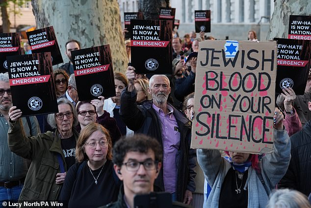 People attend a Campaign Against Antisemitism 'national emergency' rally in Whitehall, central London, on Thursday