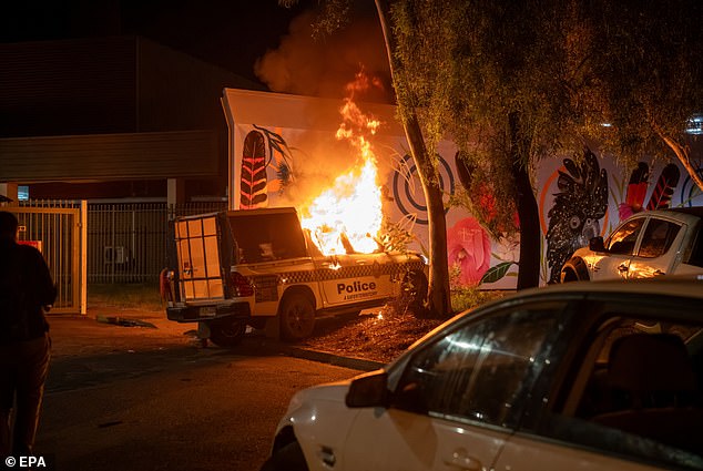 A police car was set on fire outside the hospital Jefferson Lewis was staying at after riots broke out