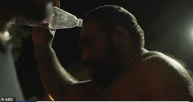 A man attempts to wash tear gas away outside Alice Springs hospital