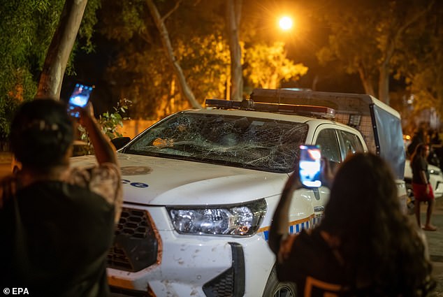 A police car was smashed up by rioters in Alice Springs overnight on Thursday
