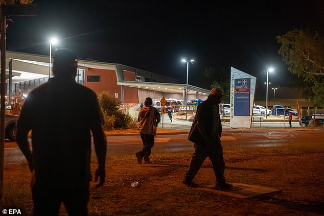 A furious mob gathered outside of Alice Springs hospital, where Lewis was taken